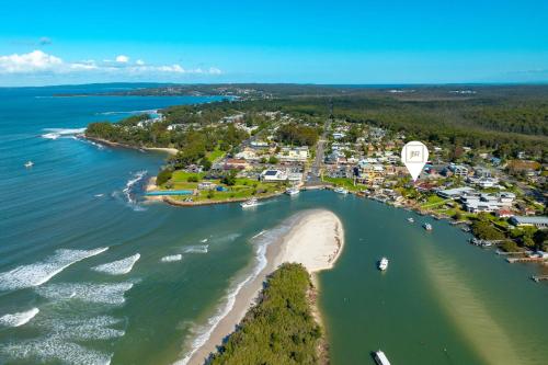 an aerial view of a beach and the ocean at The Jetty Huskisson in Huskisson