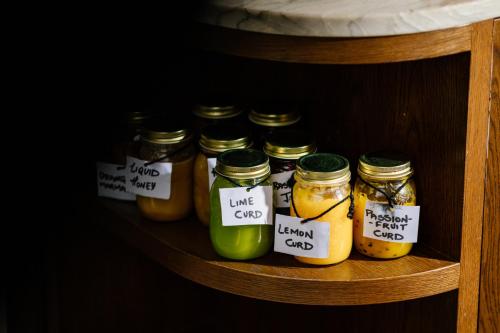 a shelf with several jars of pickles on it at SO/ Auckland in Auckland