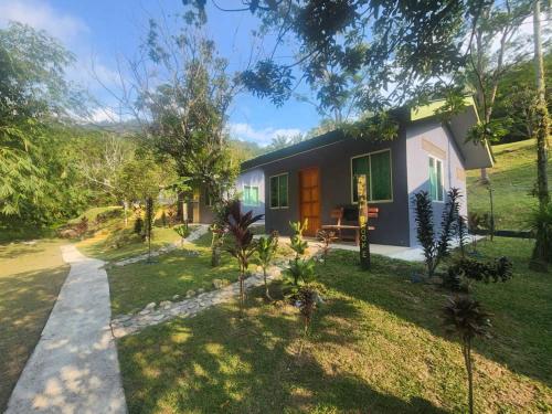a house in the middle of a yard at Ulu River Lodge, Riverbug Perak in Gopeng
