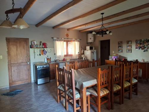 a kitchen with a table and chairs in a room at Cabaña SUSI in General Alvear