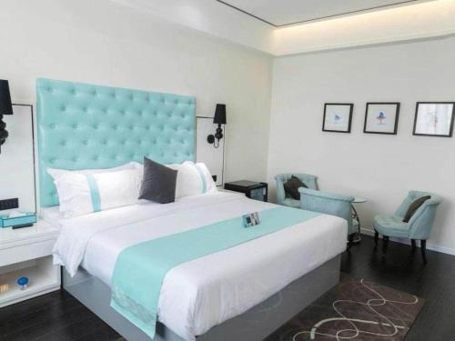 a bedroom with a large bed with a blue headboard at Xana Hotelle Xi'an GONG IP South Gate of Zhonglou in Xi'an