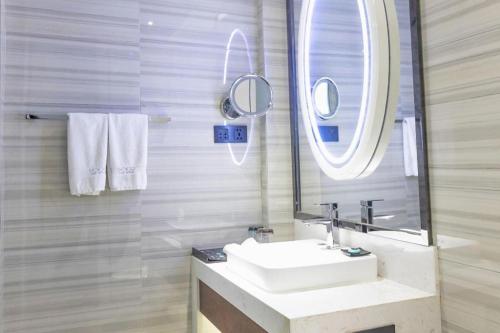 a bathroom with a sink and a mirror at Xana Hotelle Xi'an GONG IP South Gate of Zhonglou in Xi'an
