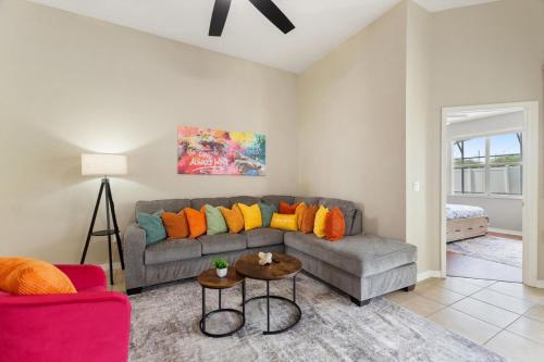 a living room with a couch and a table at Chic 4BR,Heated Pool,Jacuzzi & Dining Oasis near Disney & Legoland in Haines City