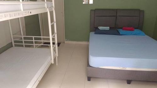 a small room with two bunk beds in it at Ulu River Lodge, Riverbug Perak in Gopeng