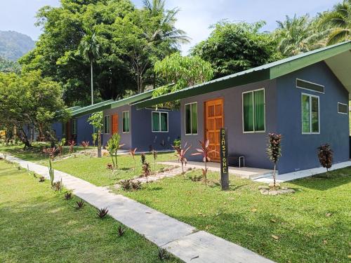 a house with a garden in front of it at Ulu River Lodge, Riverbug Perak in Gopeng