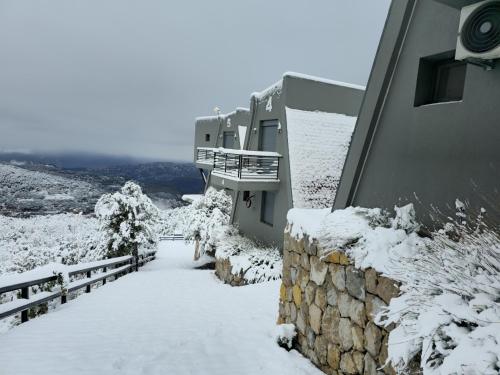 a building covered in snow next to a fence at Orion, Hills of Zaarour in Zaarour