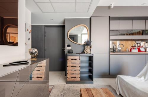 a bedroom with a bed and a desk with a mirror at Casa de Marseille in Marseille