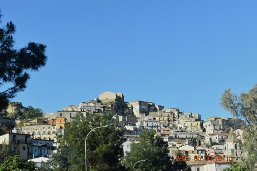 a town on top of a hill with houses at Rabat home in Tursi