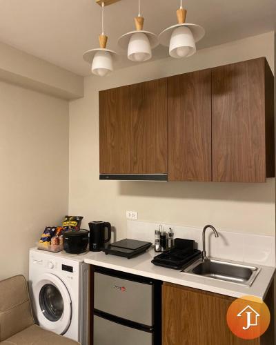 a kitchen with a sink and a washing machine at Studio With Balcony Near Beaches in Mactan in Lapu Lapu City