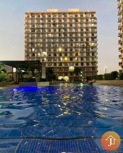 a large swimming pool in front of a large building at Studio With Balcony Near Beaches in Mactan in Lapu Lapu City