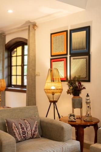 a living room with a couch and a table at Beachside Bliss Villas Candolim 10 min walk from Sinquerim Beach in Sinquerim