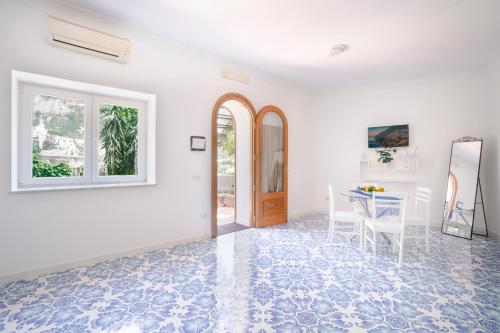 a white room with a table and a mirror at Villa Carrino Twin in Positano
