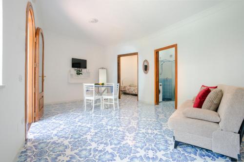 a living room with a couch and a table at Villa Carrino Twin in Positano
