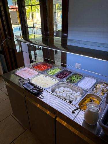 a counter with a bunch of different types of food at Hotel Pegasus-Adult Friendly in Limenas
