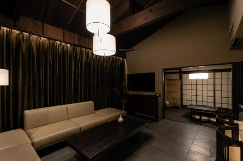 a living room with a couch and a table at FUMI hakone 森の露天風呂 in Hakone