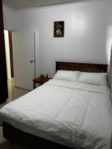 a bedroom with a large bed with white sheets at Easy Apartment- 36 Varani street flat2&flat5 in Suva