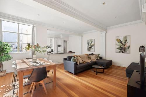 a living room with a couch and a table at 53 Malop by Regional Escapes in Geelong