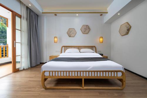 a bedroom with a large bed in a room at Phoenix Mandu River View Homestay in Fenghuang
