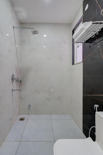 a bathroom with a shower and a toilet at The Lodgers 1 BHK Serviced Apartments Near Artemis Hospital Sector 52 in Gurgaon