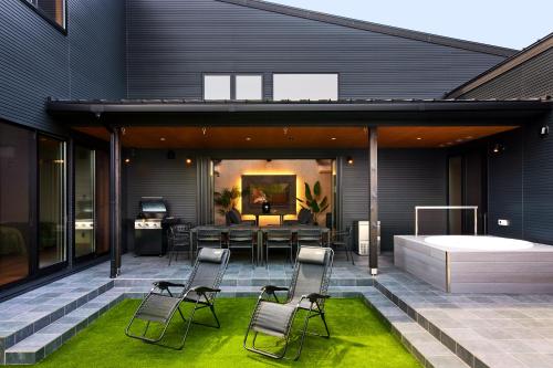 a house with a patio with chairs and a table at By The BIWAKO in Takashima