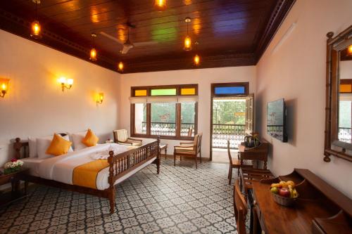 a bedroom with a large bed in a room at Koviloor Resort in Vattavada