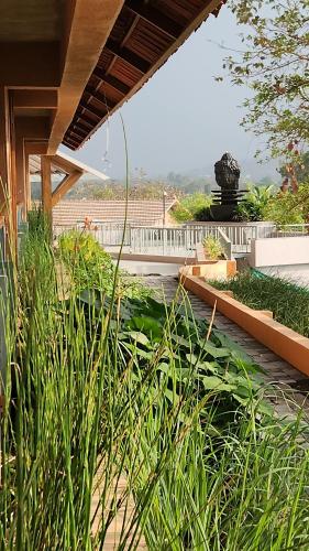 a garden with tall green plants on a patio at The Foresta Resort ,Mulshi in Paud