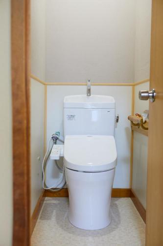 a bathroom with a white toilet in a room at Ryokan Matsushima in Yokohama