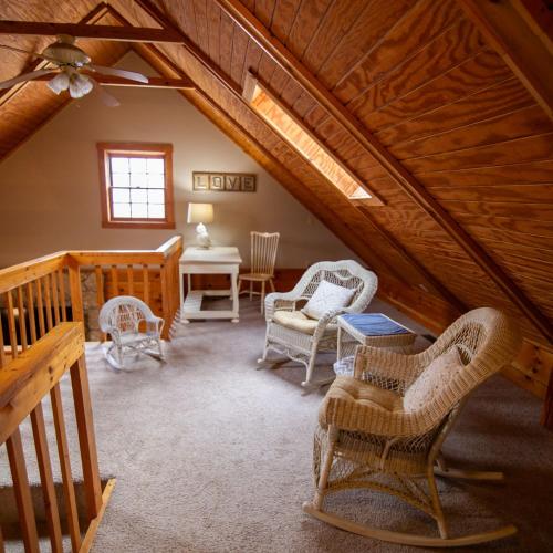 a attic room with chairs and a table at Cumberland - by The Chalets in Logan
