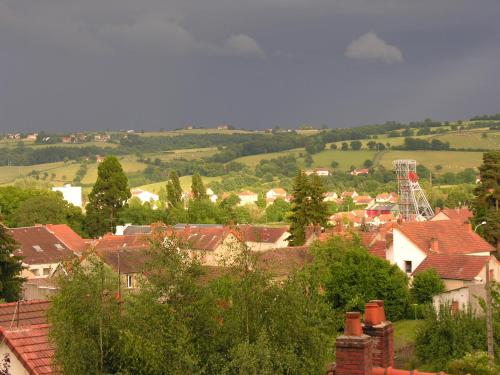a view of a town with houses and trees at La Cadanise, Suite Étoilée in Saint-Éloy-les-Mines