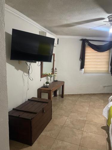 a living room with a flat screen tv on the wall at Departamento 1 tecalai San Carlos, Sonora, México in Rancho El Pozo