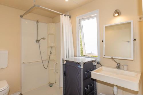 a bathroom with a sink and a shower and a toilet at Agriturismo Nonna Stella in Bibbona
