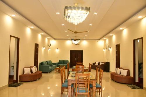 a dining room with a table and chairs at Aroma Green Farm Manesar with Pool in Bahora