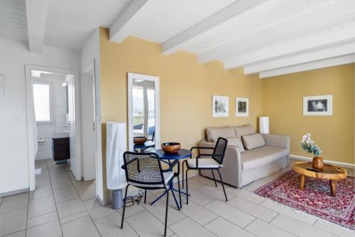 a living room with a couch and a table at UP&GREAT Apartments - Stylish City Living in Zürich