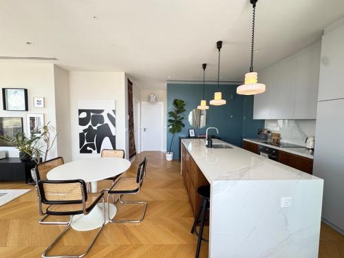 a kitchen and dining room with a table and chairs at Penthouse Living in the Heart of Nicosia in Nicosia