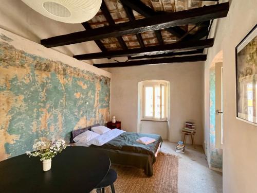 a bedroom with a bed and a painting on the wall at Piccolo Hotel in Vodnjan