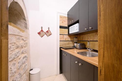 a kitchen with a sink and a counter at Palazo dei CONTI in Split Centre OLD town in Split