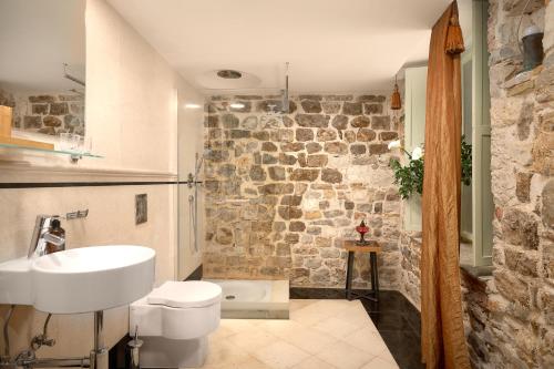a bathroom with a white toilet and a sink at Palazo dei CONTI in Split Centre OLD town in Split