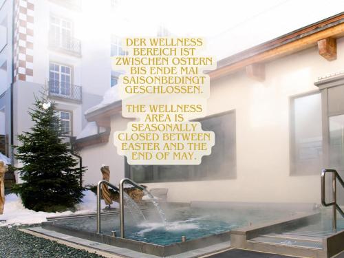 a wall with a sign on the side of a building at Familienunterkunft Schweizerhof 414 - Lenzerheide in Lenzerheide