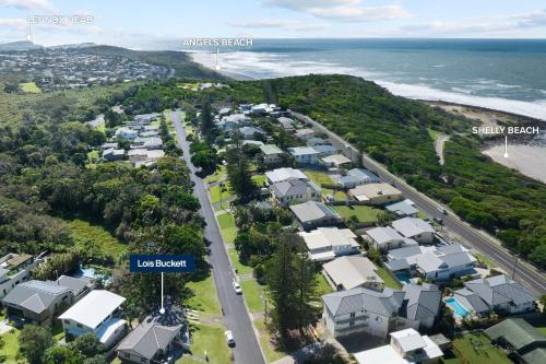 an aerial view of a city with houses and the ocean at Haere Mai 2 in East Ballina
