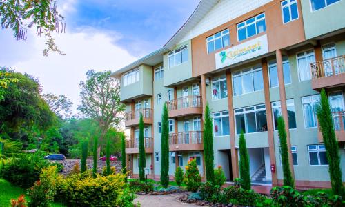a building with trees in front of it at KISIMANI ECO RESORT & SPA LTD in Isiolo