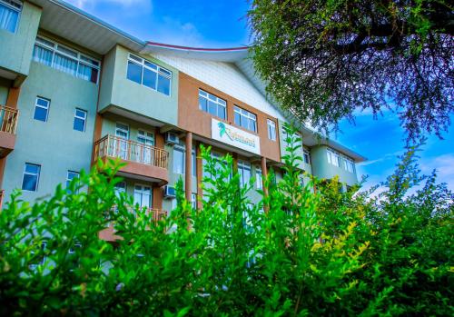a building with trees in front of it at KISIMANI ECO RESORT & SPA LTD in Isiolo