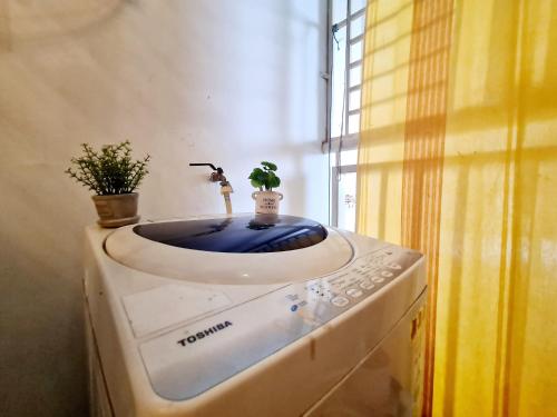 a bathroom with a sink with two plants on it at Subang SS16 Tiara Nu Empire SJMC Sunway Pyramid Lagoon Sunway Hospital INTI in Subang Jaya