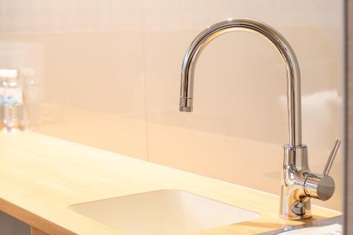 a kitchen sink with a stainless steel faucet at Hotel Naranohamori in Nara