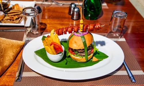 a plate with a sandwich and fries on a table at KISIMANI ECO RESORT & SPA LTD in Isiolo