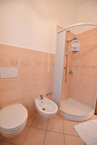 a bathroom with a toilet and a shower and a sink at Haidi House in Agerola