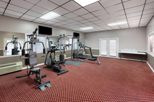 a gym with several treadmills and elliptical machines at Super 8 by Wyndham Temple S General Bruce in Temple