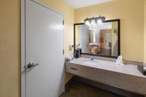 a bathroom with a sink and a mirror at Super 8 by Wyndham Temple S General Bruce in Temple