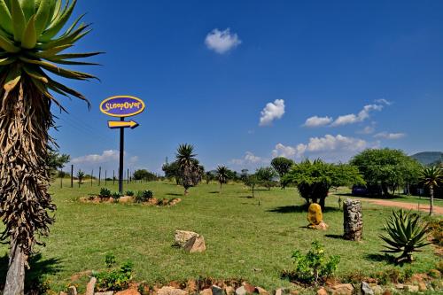 a sign in the middle of a grass field at SleepOver Moria in Moria