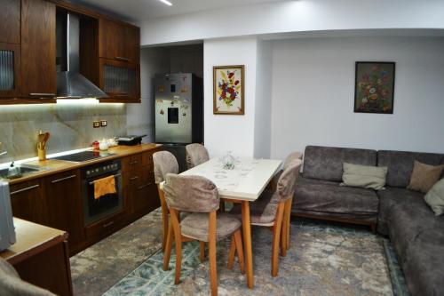 a kitchen and living room with a table and a couch at Guesthouse Belle View Old Town in Berat