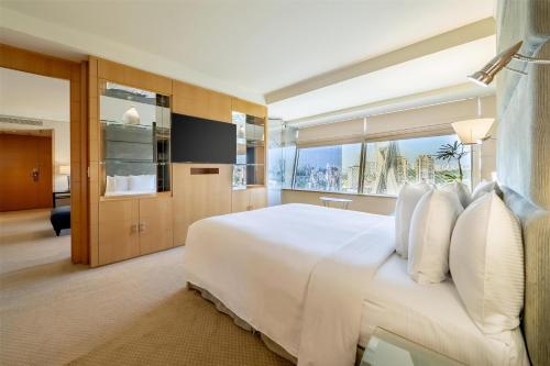 a bedroom with a large white bed and a large window at Hilton Sao Paulo Morumbi in Sao Paulo